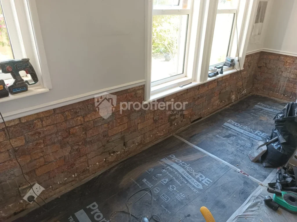 Exposed brick wall prepared for DPC injection in Bournemouth
