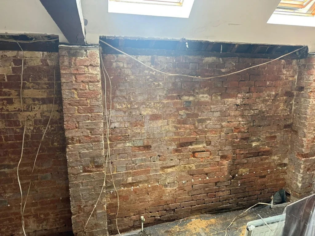 Lateral penetrating damp through a retaining wall in Wimborne
