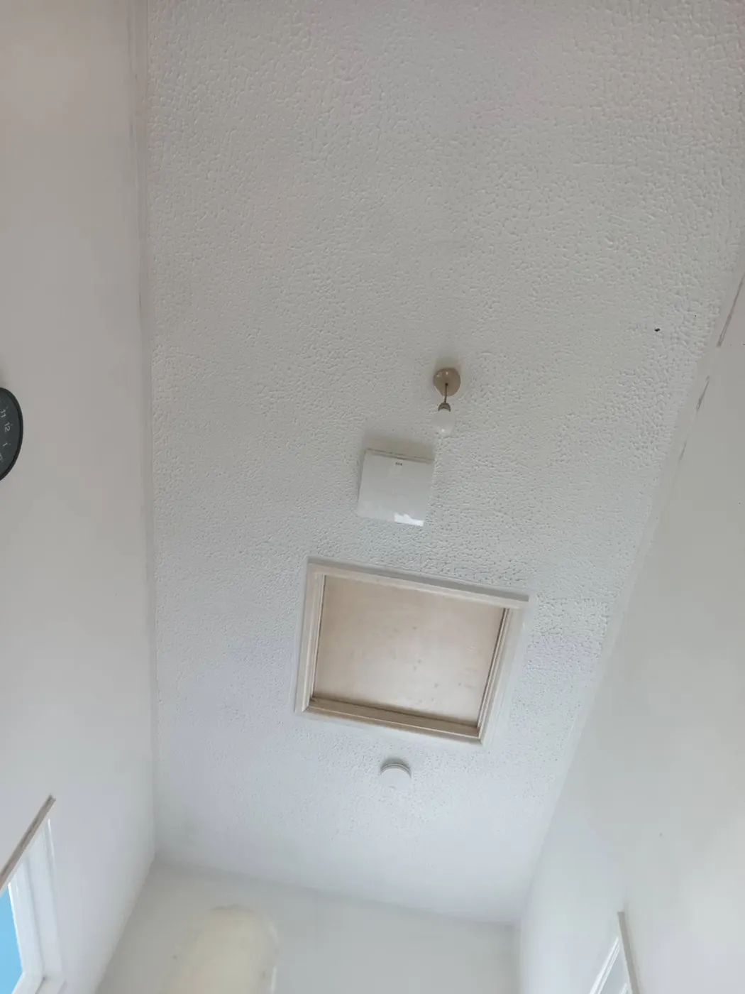 PIV diffuser fitted on the landing ceiling beside the loft hatch, supplying filtered fresh air to the whole house