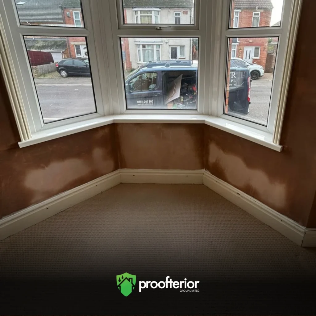 Proofterior damp proofing and wall restoration near bay window in Dorset home.