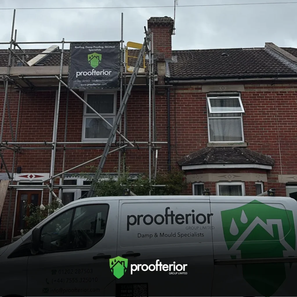 Proofterior damp proofing project with scaffolding and van outside Hampshire property.