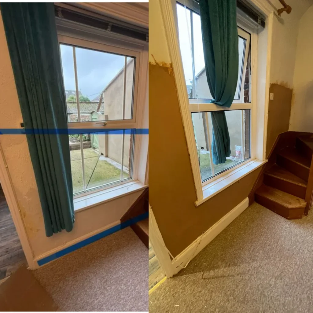 Ground floor internal wall beside staircase showing damp damage prior to remedial works, highlighting rising damp concerns.