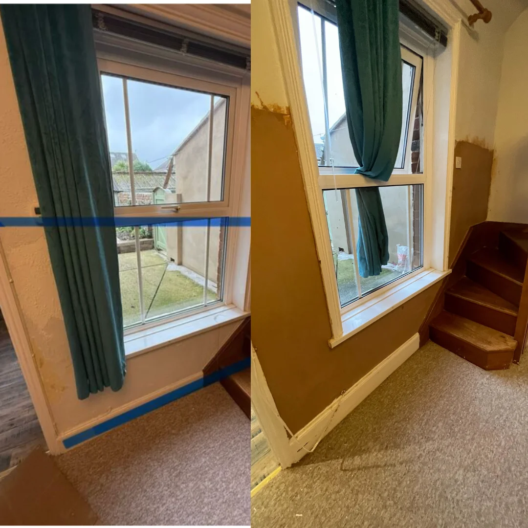 Ground floor internal wall beside staircase showing damp damage prior to remedial works, highlighting rising damp concerns.