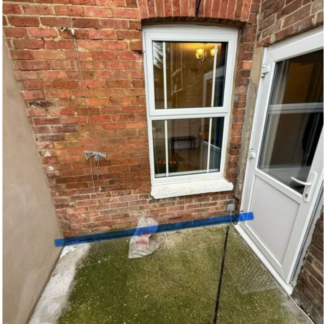 Internal wall beneath window showing damp damage and salt contamination prior to Proofterior Dry System installation.