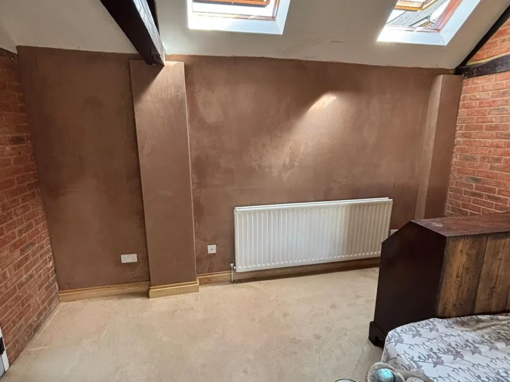completed retaining wall waterproofing project in Wimborne Dorset showing dry walls, finished plaster, and restored living space