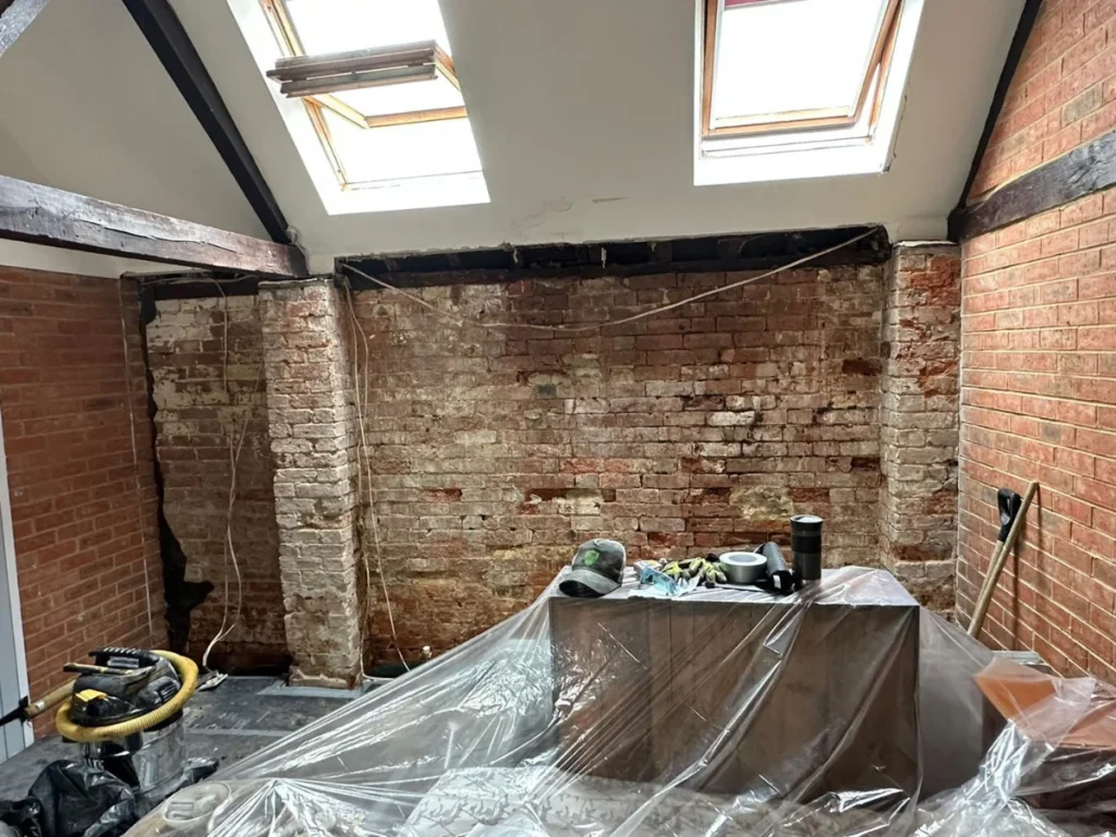 retaining wall treated with waterproof coating in Wimborne to stop lateral penetrating damp before membrane installation