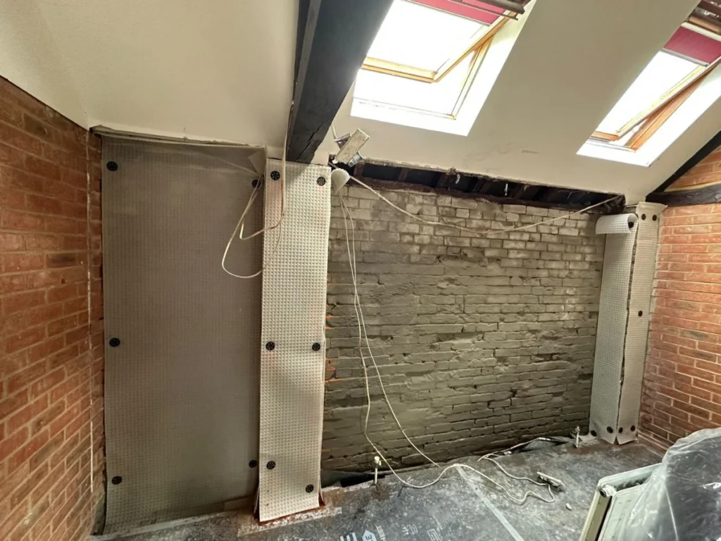 fully waterproofed retaining wall in Dorset with smooth plaster finish after lateral damp treatment and membrane system installation